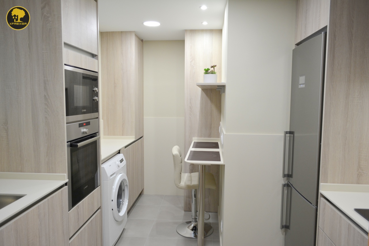 a kitchen with a counter top and a refrigerator