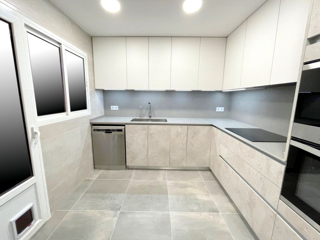 a kitchen with white cabinets and a sink