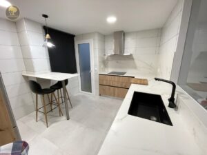 a kitchen with a bar and stools