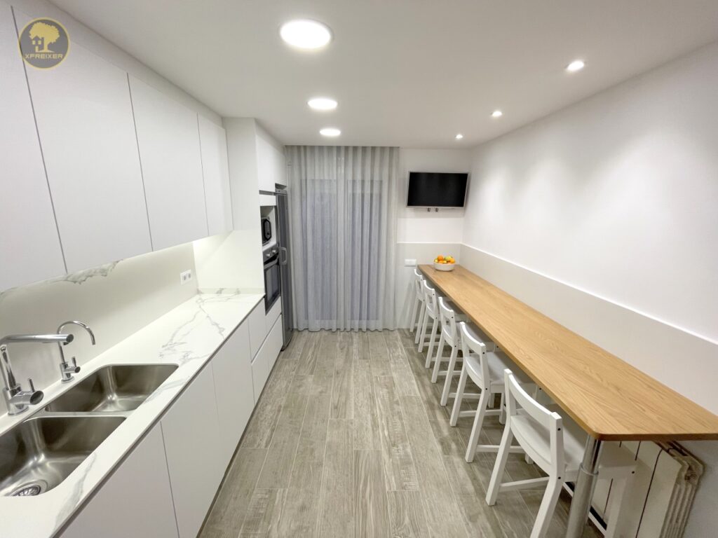 a kitchen with white cabinets and white countertops