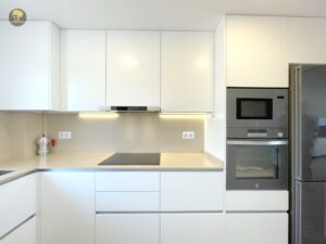 a kitchen with white cabinets and a microwave oven