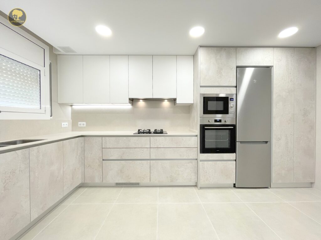 a kitchen with white cabinets and appliances