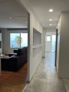 a hallway with a couch and a refrigerator