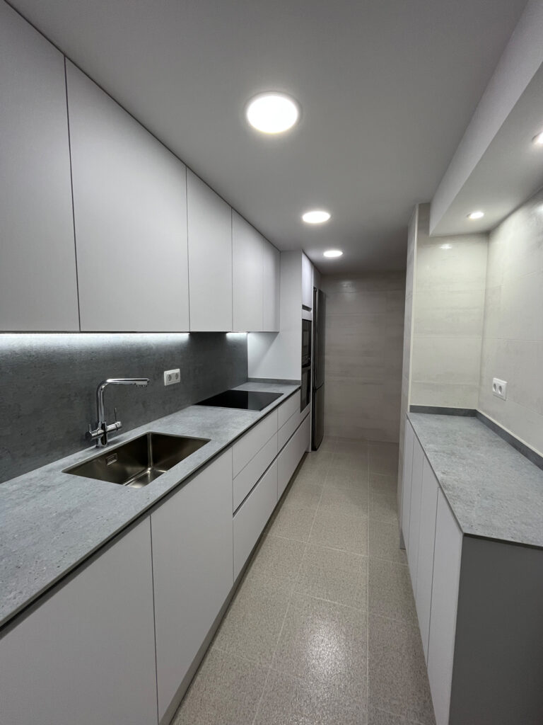 a kitchen with white cabinets and a sink