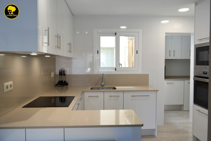 a kitchen with white cabinets and a sink