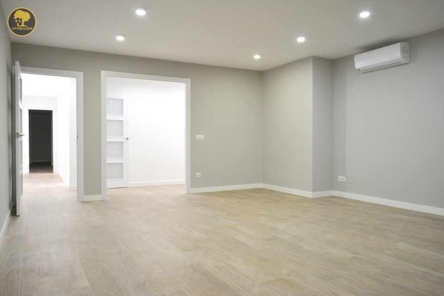 a room with a wood floor and a white door