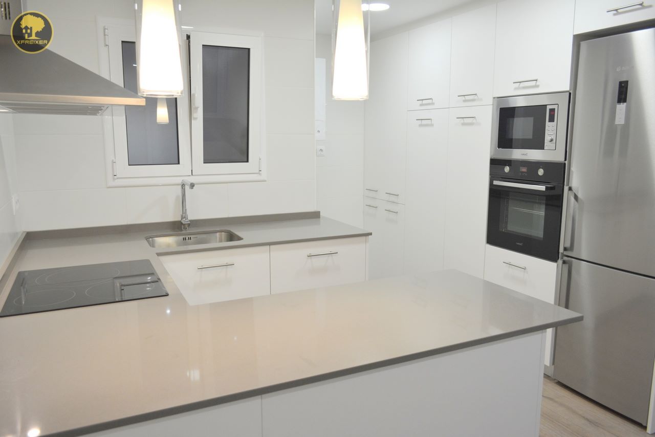 a kitchen with white cabinets and a sink