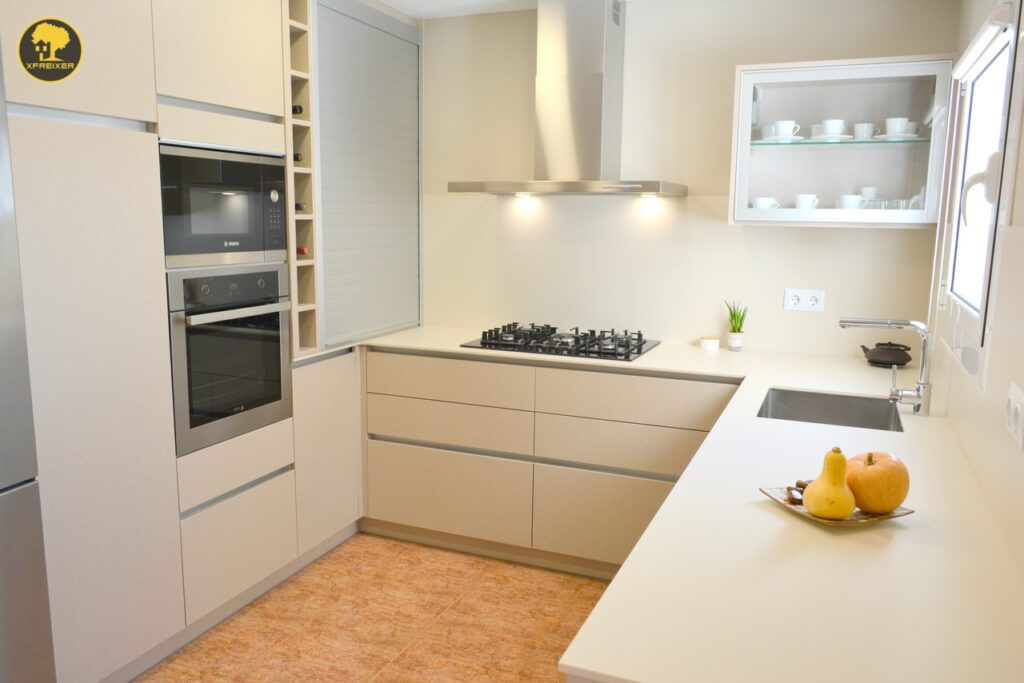 a kitchen with white cabinets and a white countertop