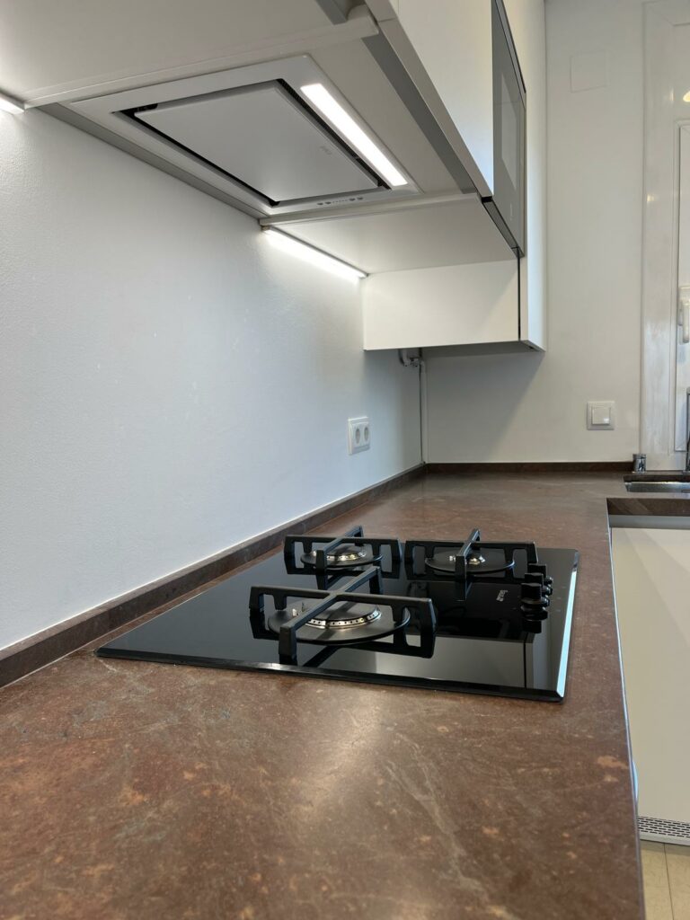 a stove top with two burners on a counter top